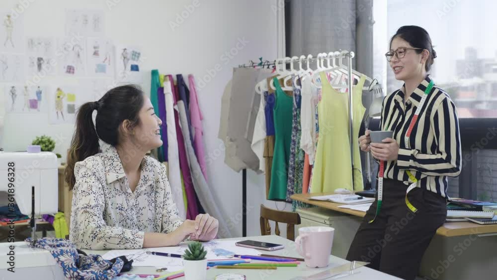 young asian women fashion designers talking and drinking coffee while ...