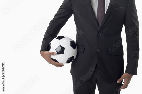 Fototapeta Naklejka Na Ścianę i Meble -  Soccer manager holding a ball
