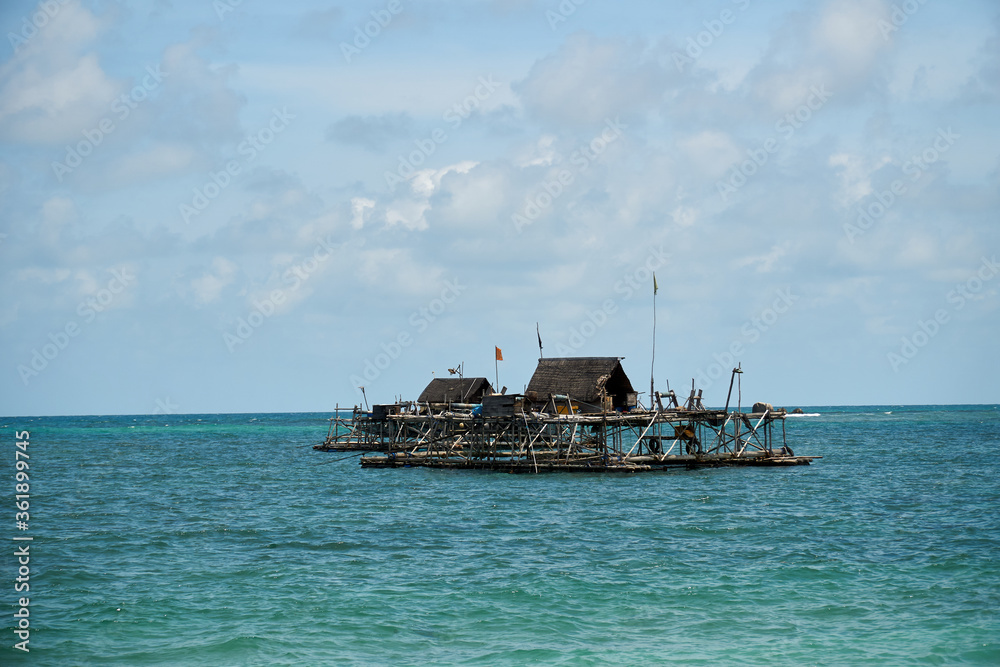 Boats and wooden fisherman house at the sea Boats and wooden fisherman house at the sea