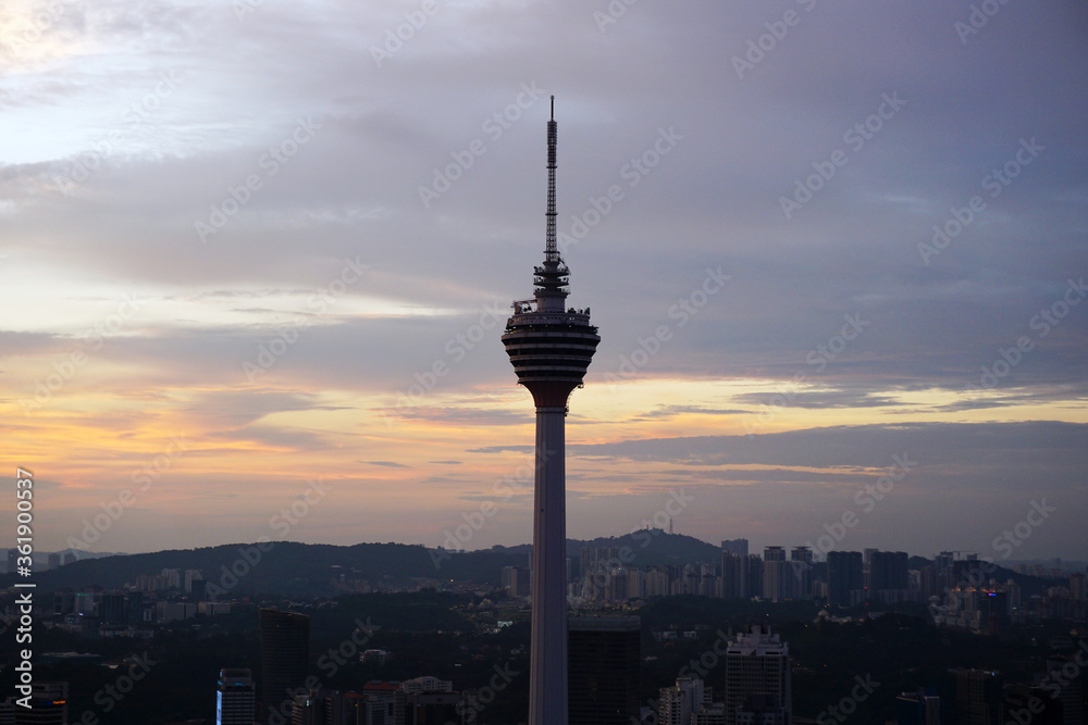 Naklejka premium Skyline of KL tower and skyscrapers during sunset 