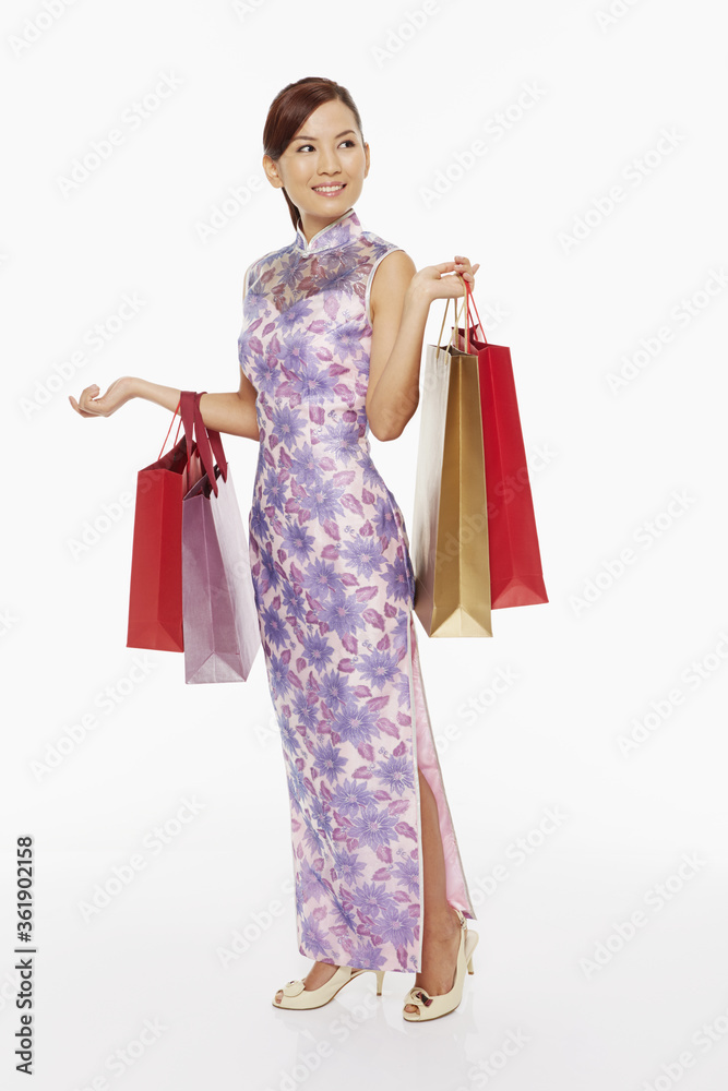 Woman in traditional clothing carrying shopping bags Woman in traditional clothing carrying shopping bags