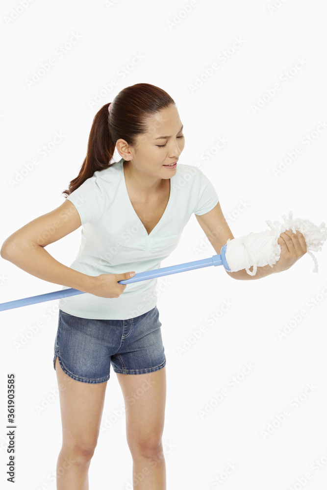 Woman squeezing the head of a mop
