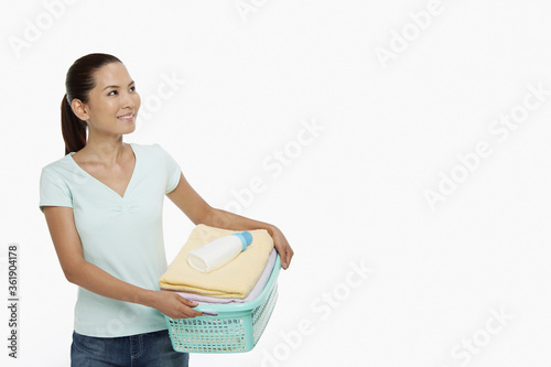 Woman carrying a basket of clean laundry