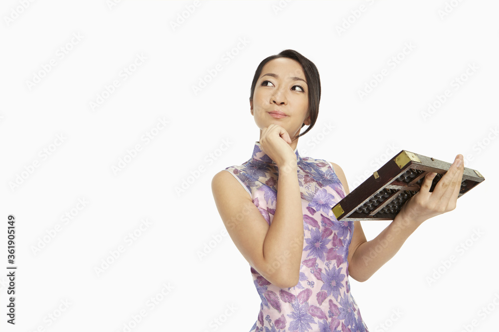 Woman in traditional clothing holding up an abacus Woman in traditional clothing holding up an abacus