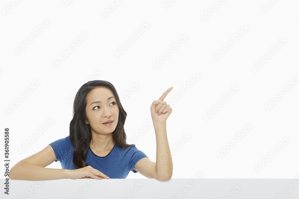 Cheerful woman pointing to the left Cheerful woman pointing to the left