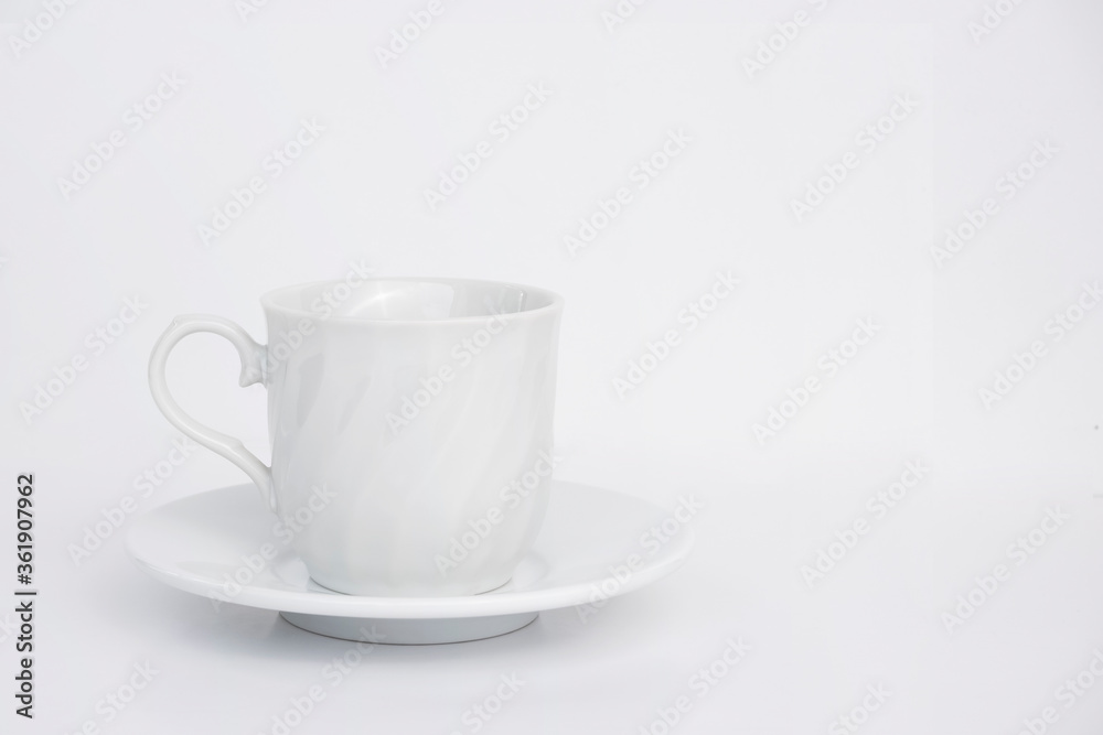 Vintage white ceramic coffee cup and saucer on white background