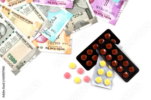 Pile of pharmaceutical drug, medicine pills and indian money, cost of healthcare and medical insurance concept