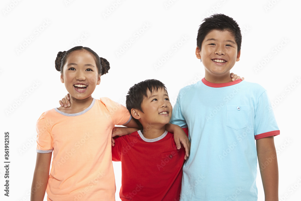 Three children with arms around smiling at the camera Three children with arms around smiling at the camera