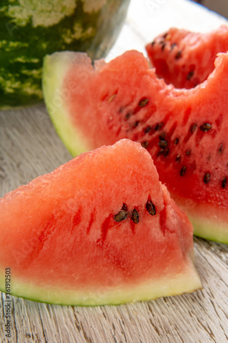 Fresh ripe sliced watermelon on wooden rustic background