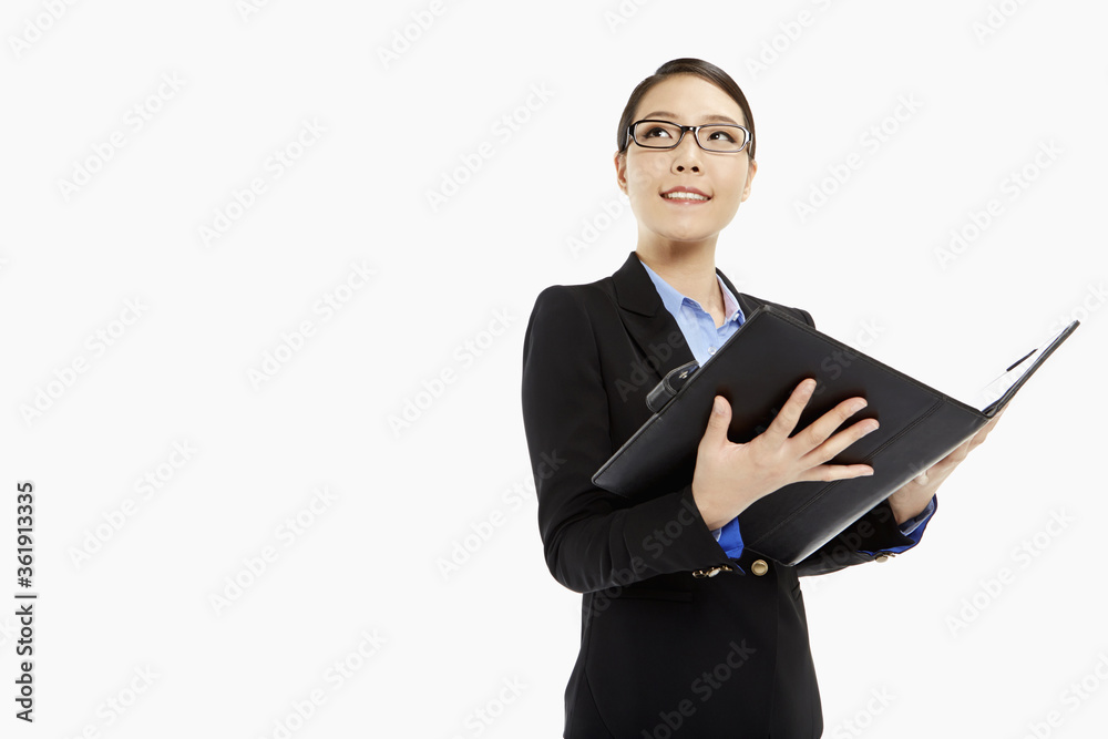 Businesswoman reading notes from a folder Businesswoman reading notes from a folder