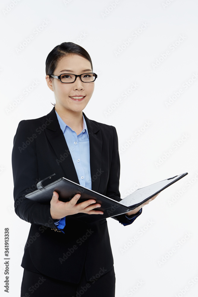 Businesswoman reading notes from a folder