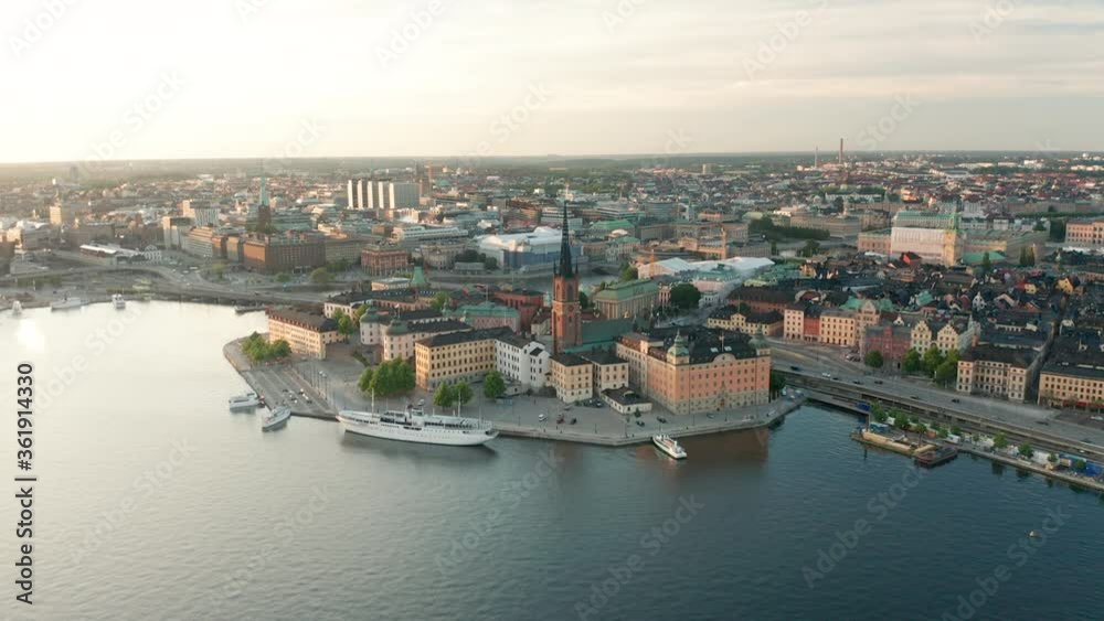 Stockholm City sunset, aerial view over skyline, rooftops & buildings in the capital of Sweden. View of Riddarholmen & City Center.