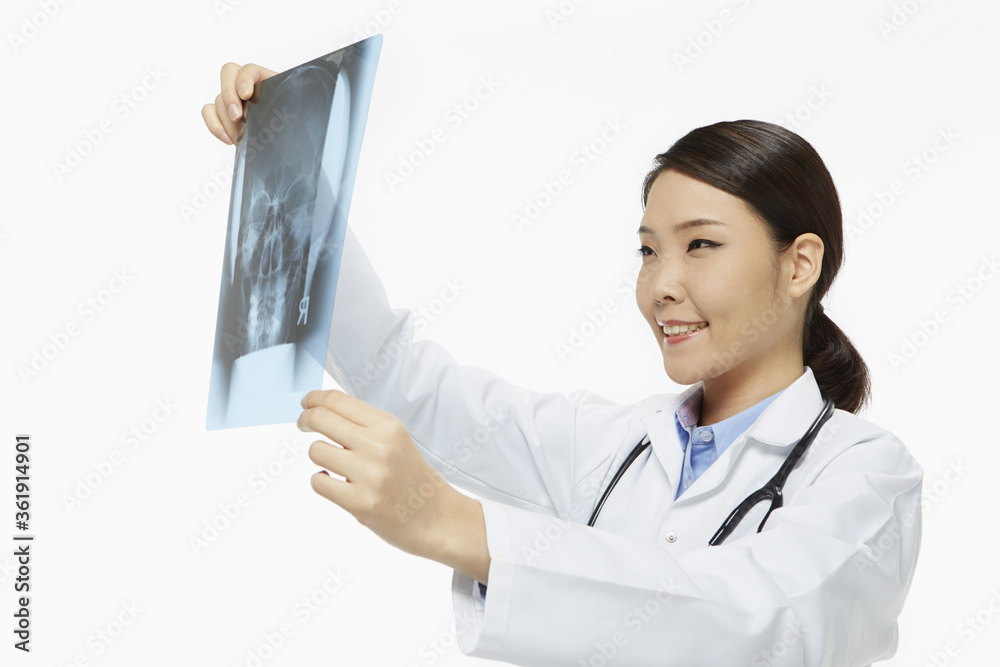 Medical personnel checking up on an x-ray film Medical personnel checking up on an x-ray film