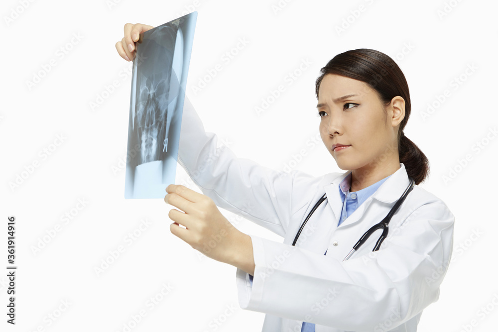 Medical personnel checking up on an x-ray film Medical personnel checking up on an x-ray film