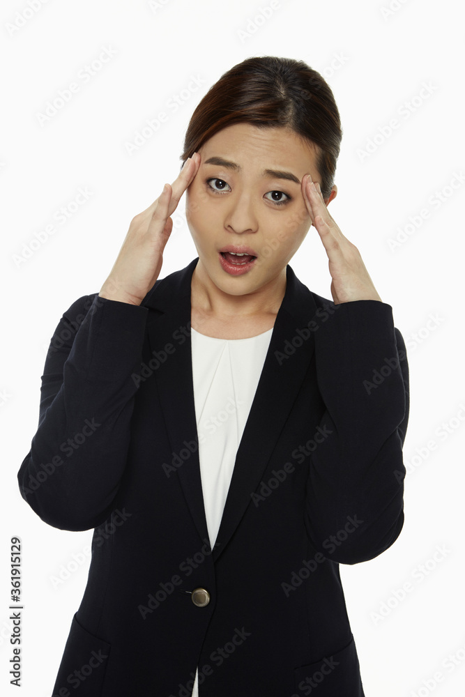 Businesswoman touching her forehead Businesswoman touching her forehead
