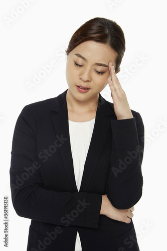 Businesswoman touching her forehead