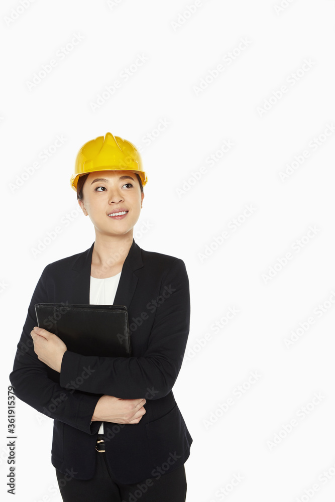 Female architect smiling and holding a folder Female architect smiling and holding a folder