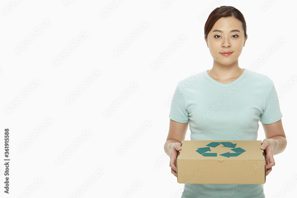 Woman holding up a recyclable box Woman holding up a recyclable box