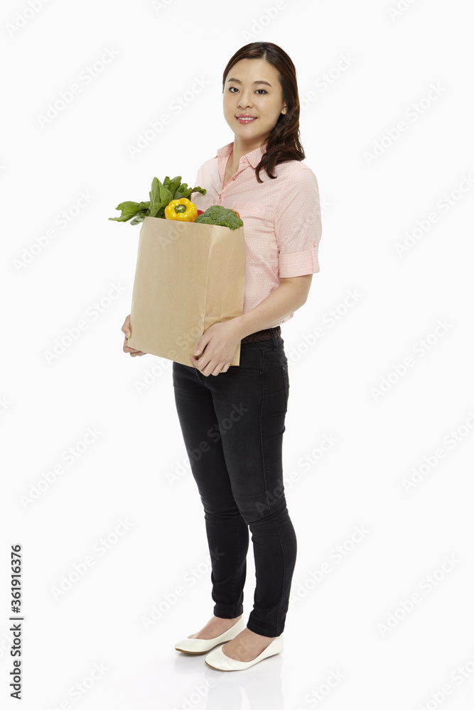 Cheerful woman with a bag of groceries Cheerful woman with a bag of groceries