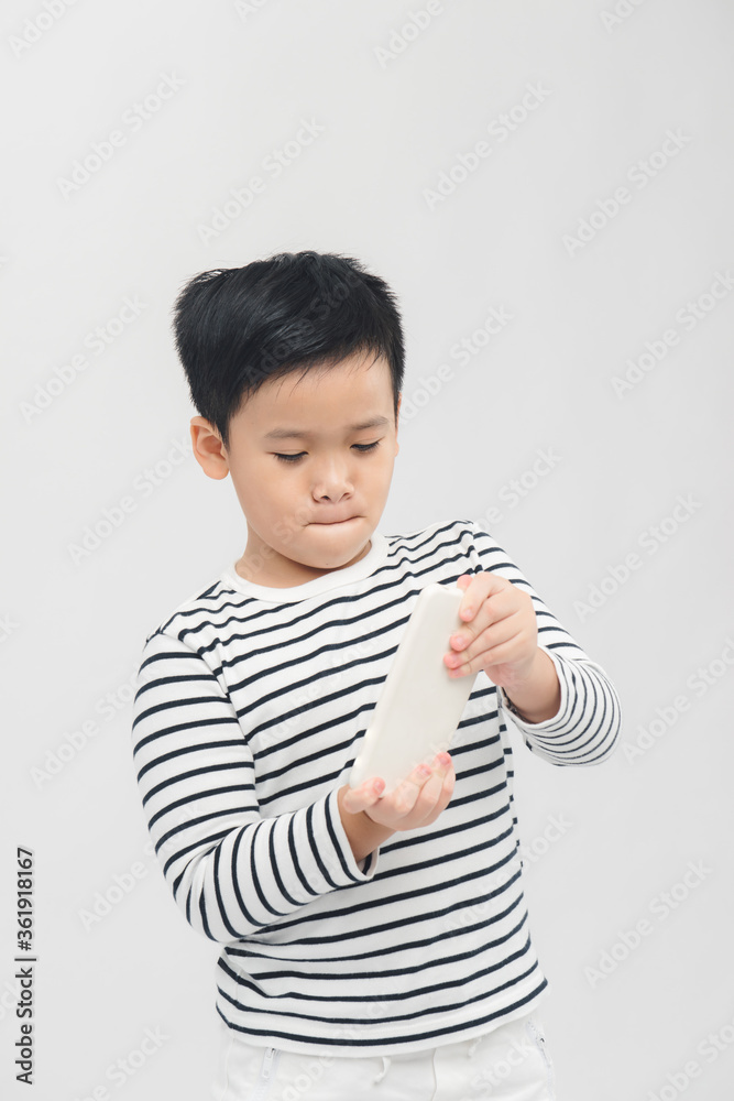 Happy child holding mobile phone. Addicted kid of social networks. Happy child holding mobile phone. Addicted kid of social networks.