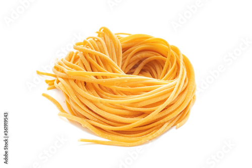 Fresh colored spaghetti pasta with carrots rolled in a nest isolated on a white background