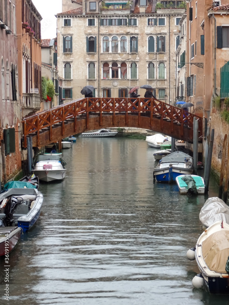 bridge over canal in rainy Venice, Italy