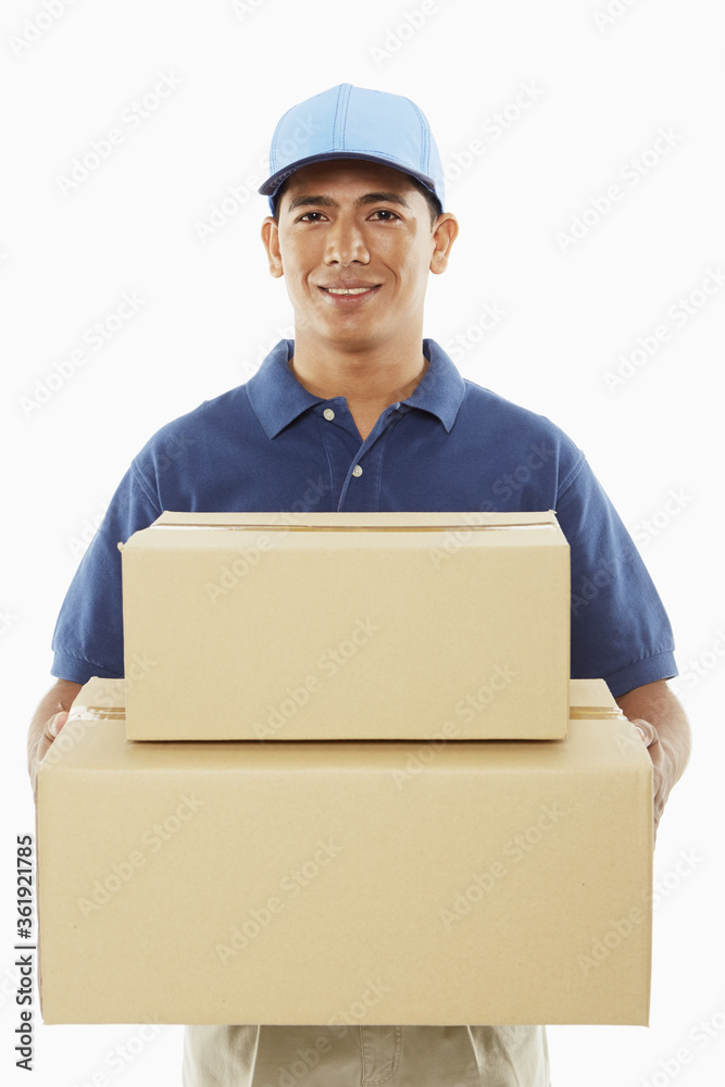 Delivery person carrying cardboard boxes Delivery person carrying cardboard boxes