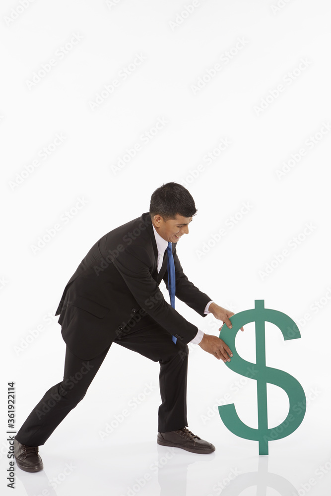 Businessman pulling the dollar sign Businessman pulling the dollar sign