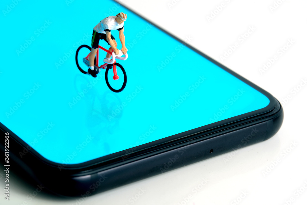 Bike cycling trainer and tracing app. A cycling above smartphone. Miniature  people figure conceptual photography. Stock Photo | Adobe Stock