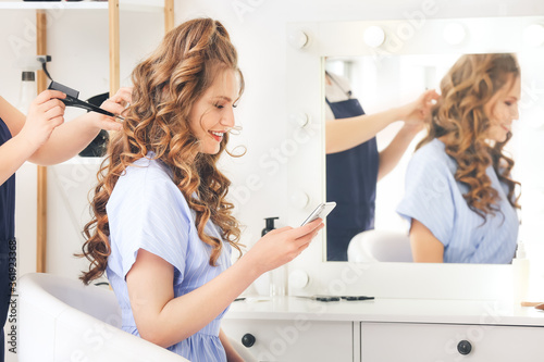 Hairdresser working with client in beauty salon