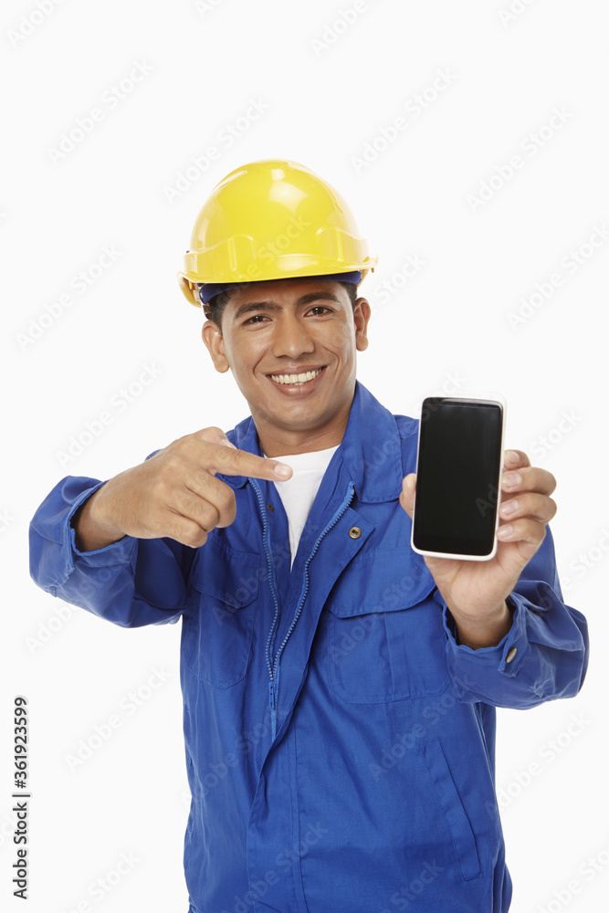 Construction worker holding up a mobile phone Construction worker holding up a mobile phone