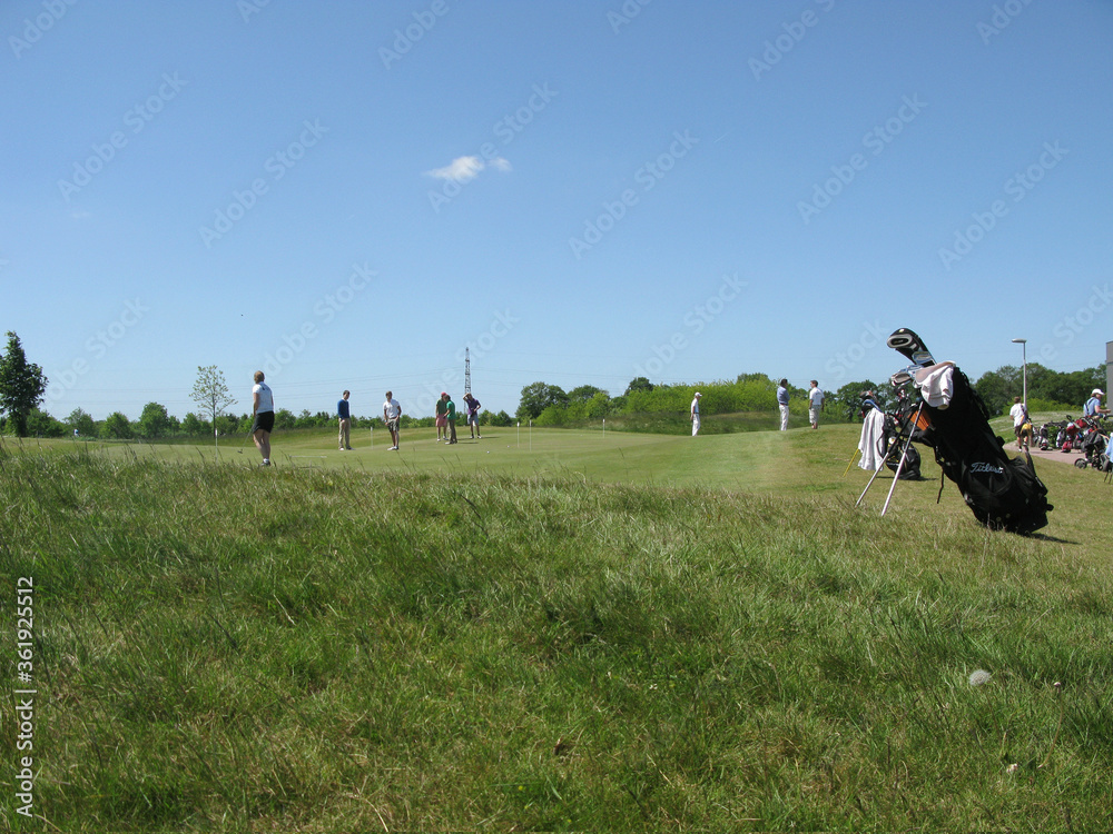 Golfers on putting green