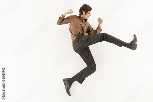 Businessman showing punching and kicking gesture