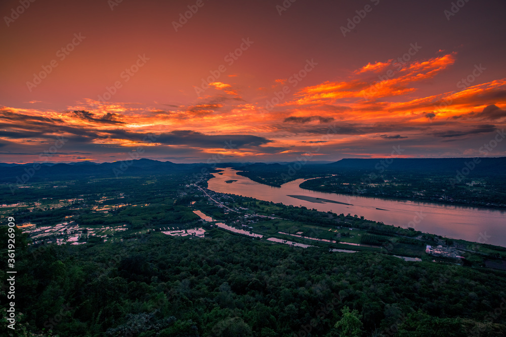 A high angle abstract background from the mountains, which can see the surrounding scenery (rivers, roads, communities, trees) and the evening twilight from the beautiful sky.