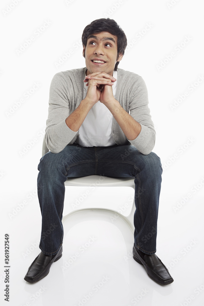 Cheerful man sitting on a chair Cheerful man sitting on a chair