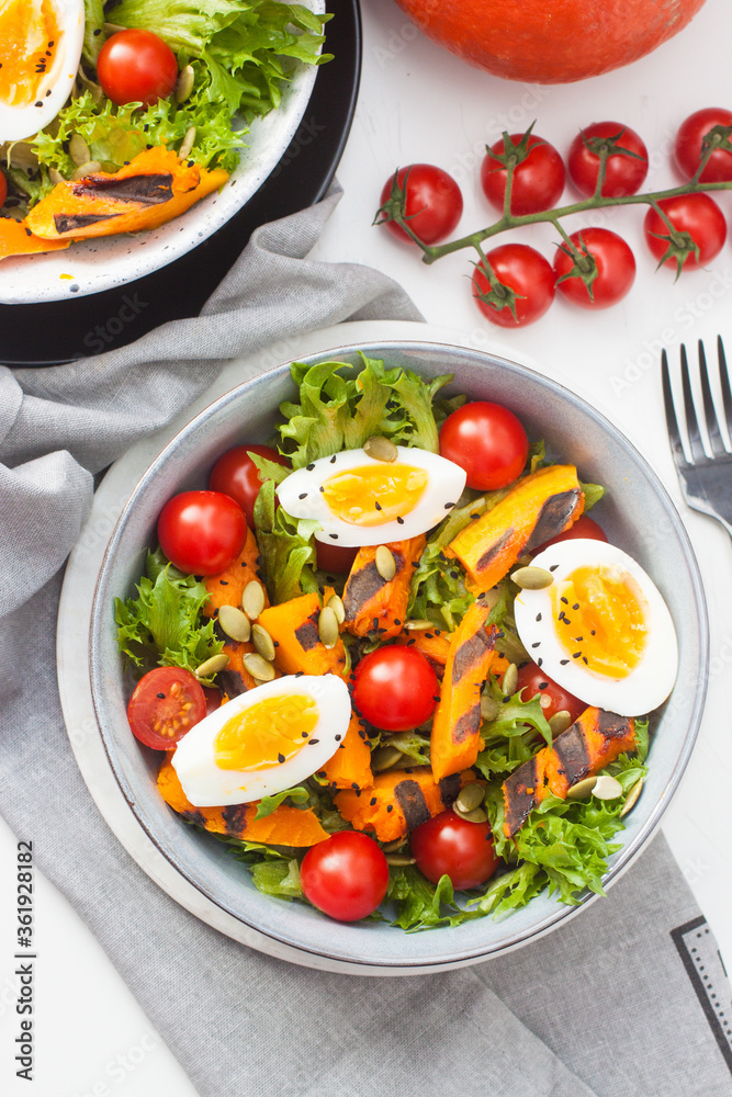 Vegetable salad with grilled carrot, cherry tomatoes, pumpkin, lettuce, boiled eggs and sesame seeds. Vegetable salad with grilled carrot, cherry tomatoes, pumpkin, lettuce, boiled eggs and sesame seeds.