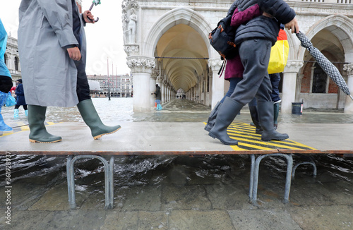 people with boot on the pedestian platform in Venice photo