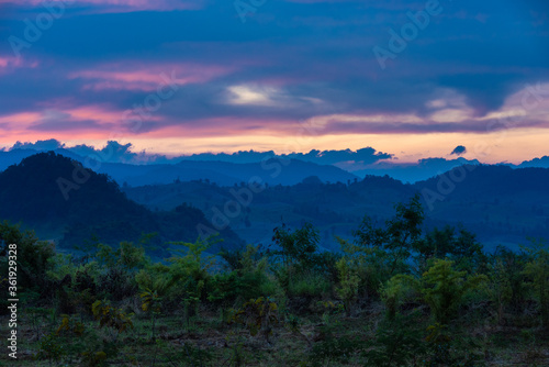 Beautiful sunrise over the mountain range at the west of thailand, nature landscape twilight background .