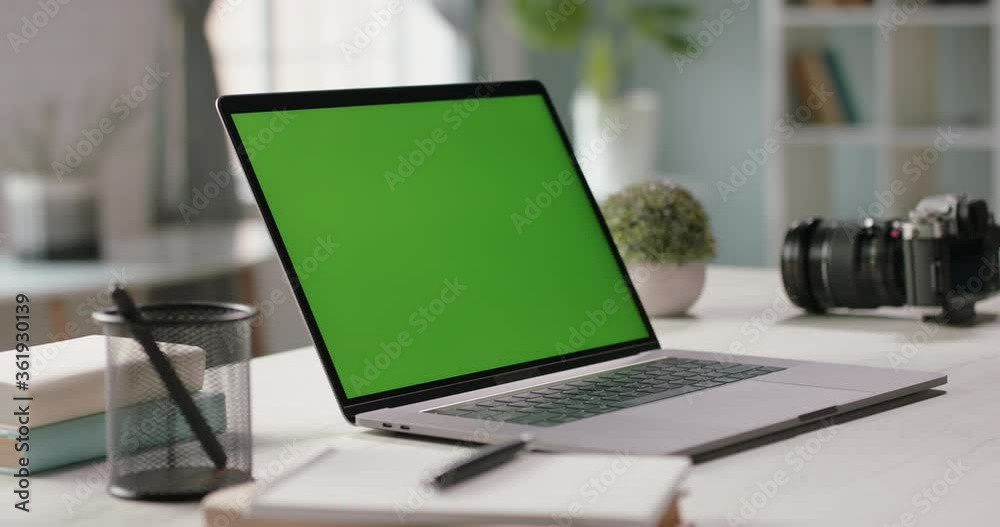 The table of distant worker at home. Modern laptop computer with chroma key green screen. Remote work, distance learning, technology concept close up 4k video template The table of distant worker at home. Modern laptop computer with chroma key green screen. Remote work, distance learning, technology concept close up 4k video template