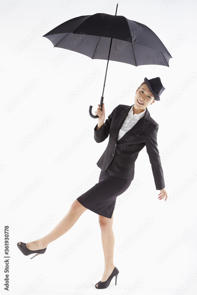 Cheerful businesswoman posing with an umbrella Cheerful businesswoman posing with an umbrella
