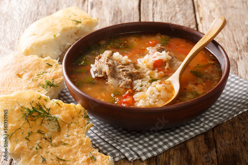 Kharcho soup in a bowl served with Georgian bread close-up on the table. horizontal