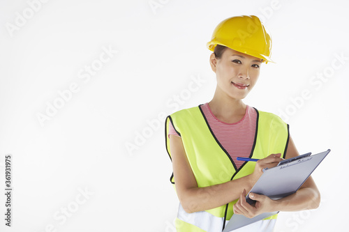 Construction worker writing down notes