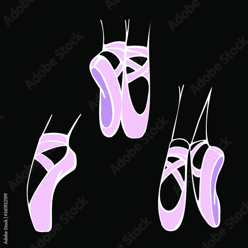 Ballerina's feet in pink pointe shoes on the black background