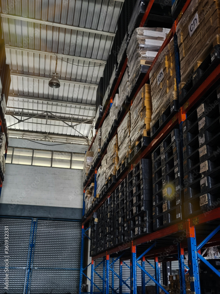 Warehouse cargo building store, warehouse interior with shelves, pallets and boxes for stock and sorting shipment goods in freight, logistics and transportation industrial
