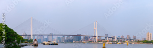 Panorama view of Nanpu Bridge across the Huangpu River, in Shanghai, China, on a cloudy day.