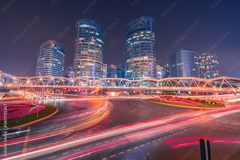 Night view of a crossroad with modern buildings and traffic in Shanghai, China.