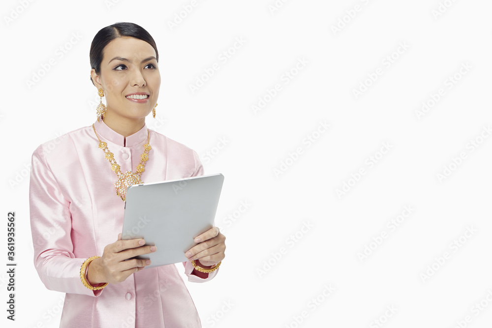 Woman in traditional clothing using a digital tablet Woman in traditional clothing using a digital tablet