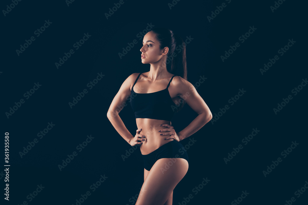Obraz premium Portrait of her she nice-looking attractive gorgeous content sportive strong lady perfect shape form figure fitness bikini model body builder pilates isolated over black background