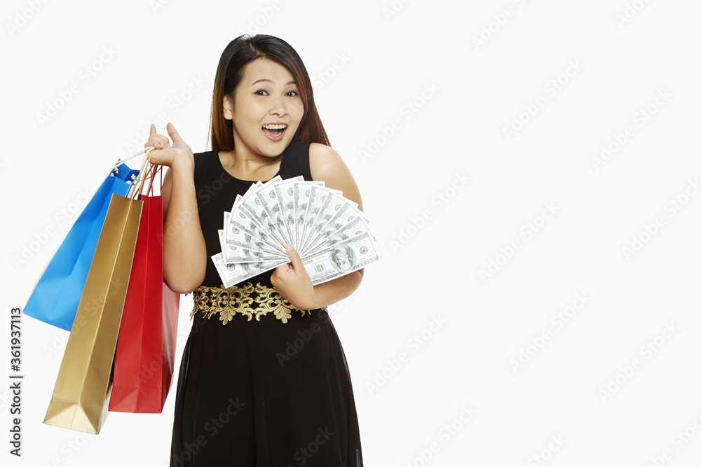 Woman with a lot of money carrying paper bags