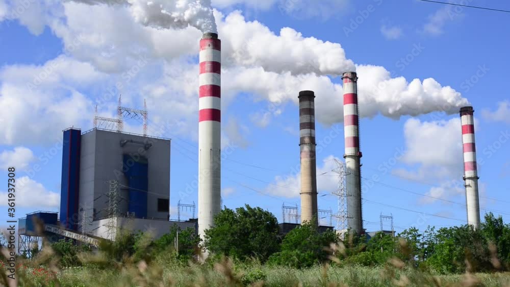 industrial landscape, the pipes of the thermal power plan white smoke on a clear blue sky , global warming pollution concept